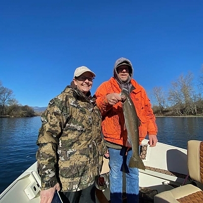Couple fishing on boat.